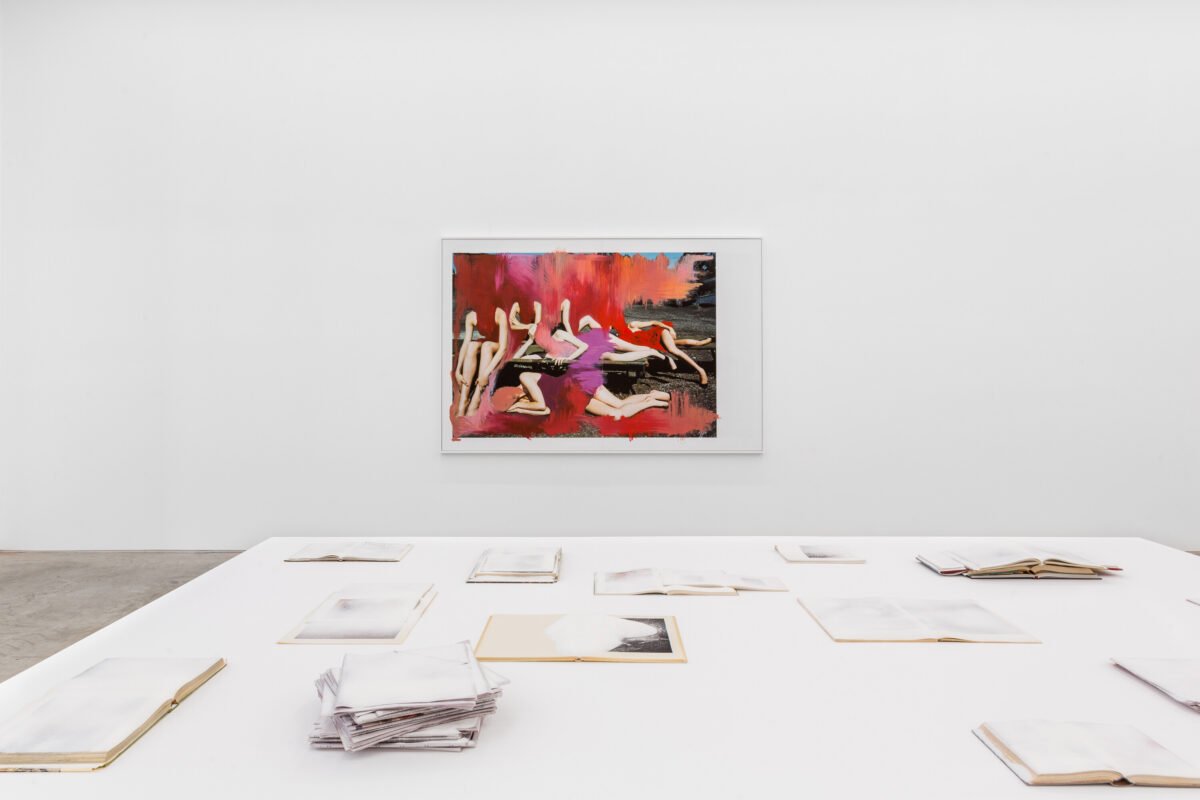 This image depicts an artwork by Amie Dicke titled "Closed Eyes II." This artwork was created in 2024 and measures 22" x 96" x 155" [HxWxD] (55.88 x 243.84 x 393.7 cm). Its medium is Installation with newspapers, books, and sugar.